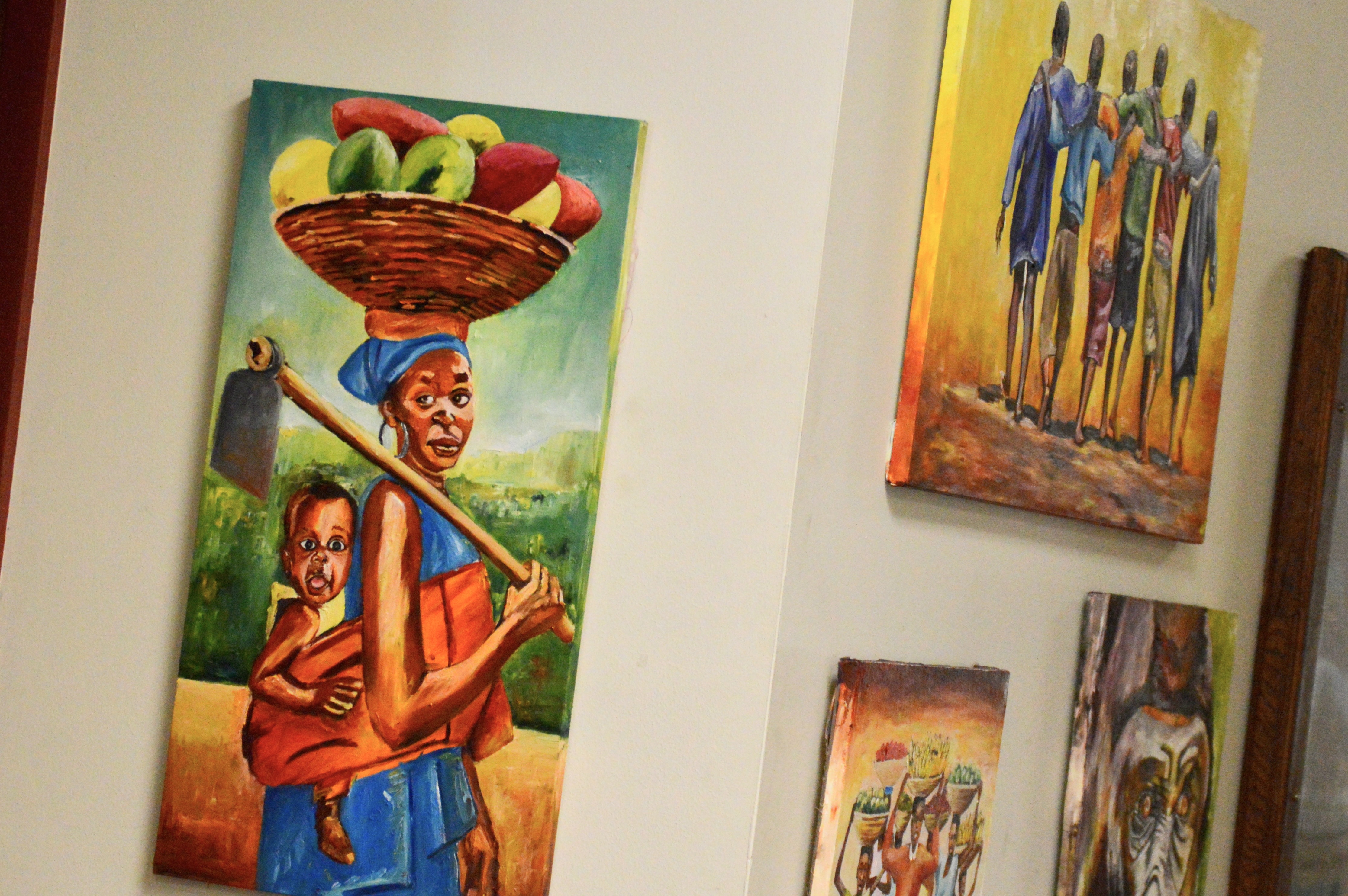Various paintings by Mwanga William on display at the Municipal Center.