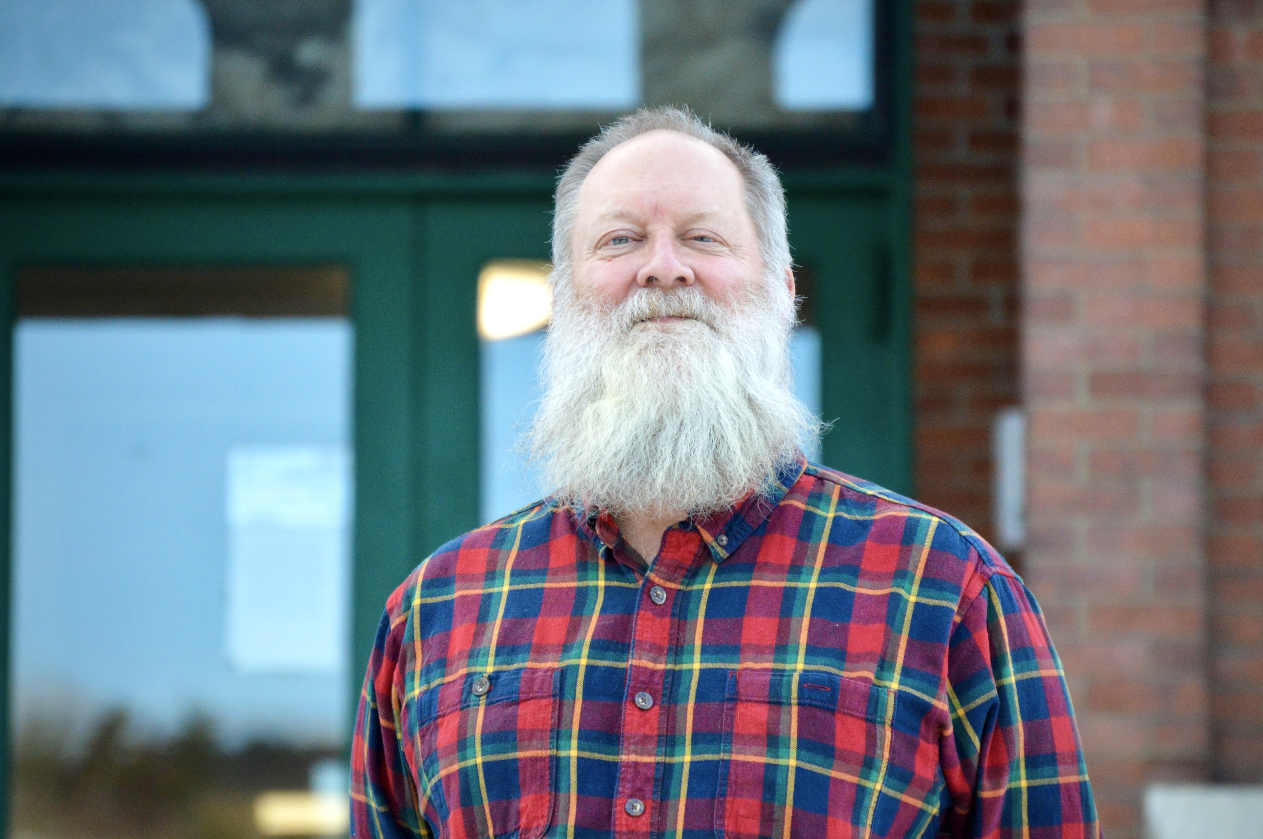 A portrait photo of Patrick Moreland standing in front of the Brattleboro Municipal Center.
